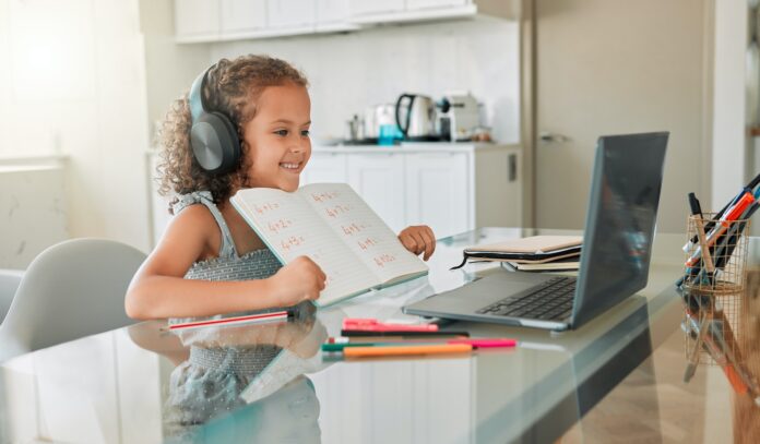 Distance learning, education and a little girl in virtual class on a laptop, smiling and showing he